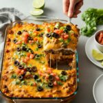Cheesy beef taco casserole topped with fresh tomatoes and green onions
